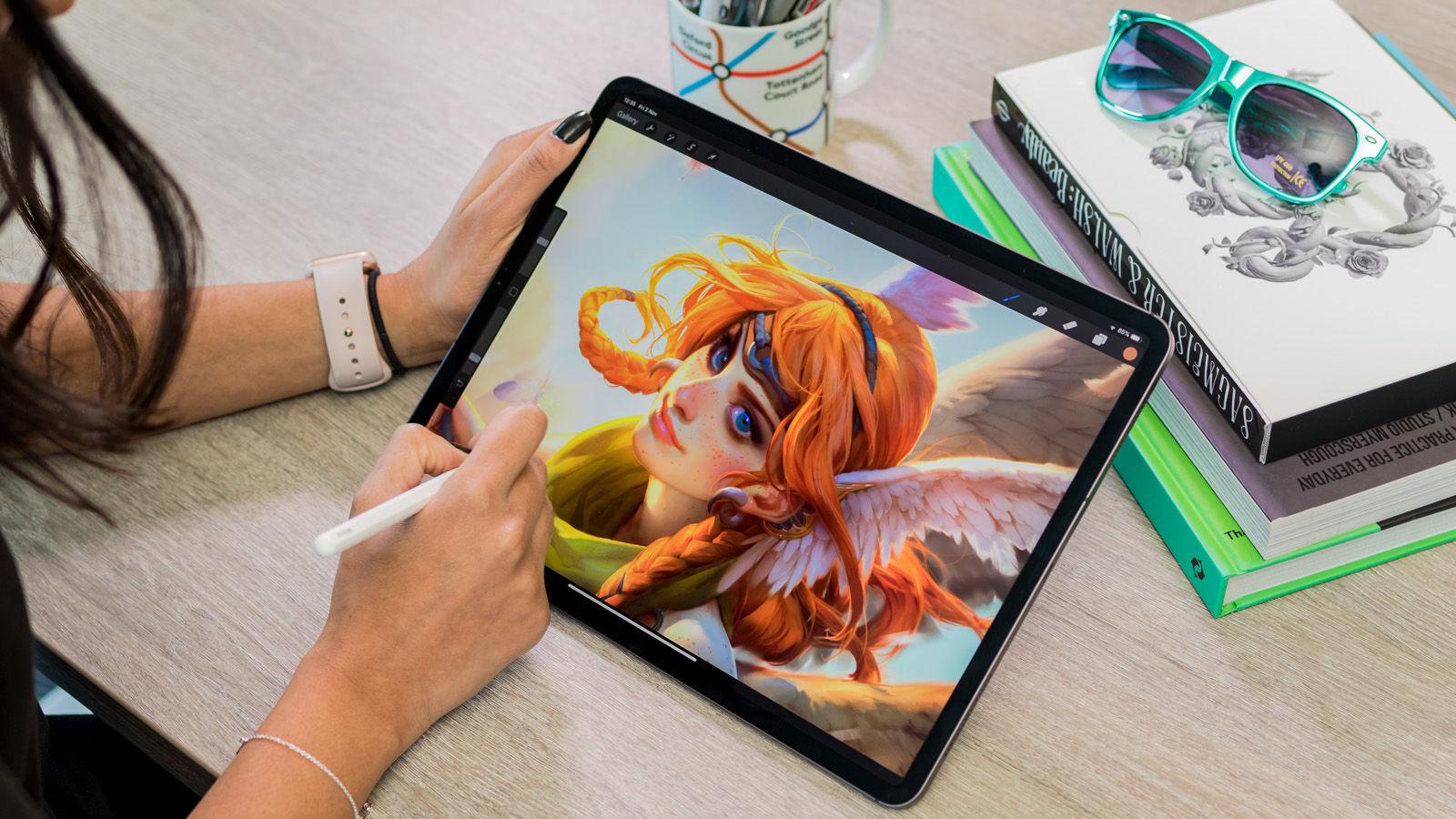 a girl drawing on an ipad pro with an apple pencil