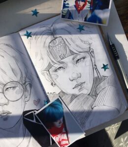 Suga drawings in a sketchbook