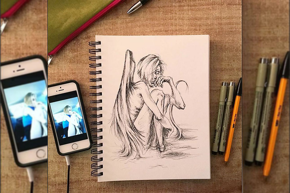 drawing an angel girl by looking at a reference picture on a phone